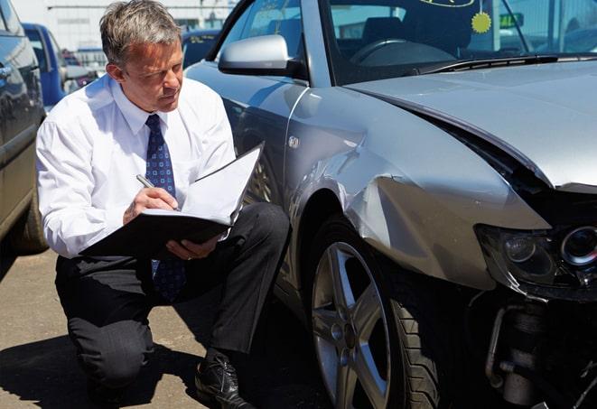 auto insurance policy document with magnifying glass